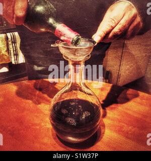 Decanting a 1996 bottle of Chateau d’Angludet red wine from bottle to decanter to remove any sediment. Stock Photo