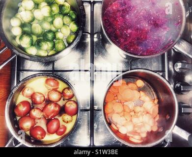 Traditional Christmas dinner vegetables cooking on gas hob Stock Photo