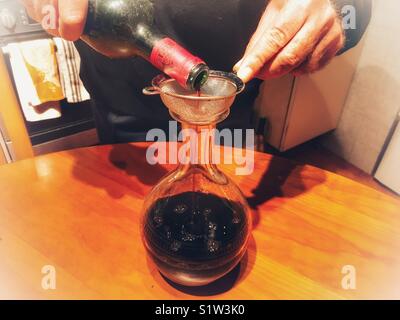 Decanting a 1996 Chateau d’Angludet, appellation Margaux controller bottle of red wine from bottle to decanter to remove any sediment. Stock Photo