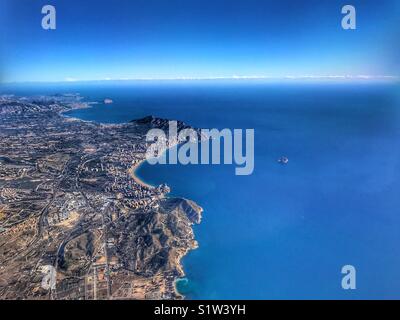 View from aeroplane. Flying over the Costa Blanca, Spain with the skyscrapers of coastal resort town of Benidorm clearly visible, plus in the distance Calpe, then Montgo mountain & Javea. Stock Photo