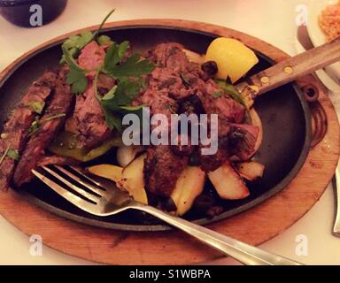 Steak fajitas on sizzling platter at upscale Mexican restaurant, New York City, USA Stock Photo
