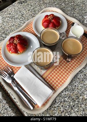 Coffees with strawberry tarts Stock Photo