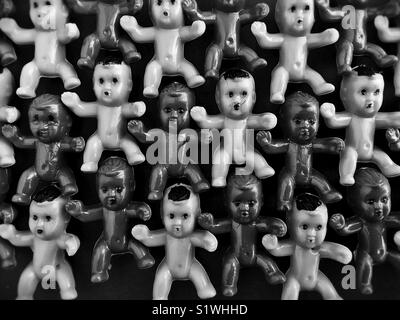 Rows of tiny plastic babies. Stock Photo