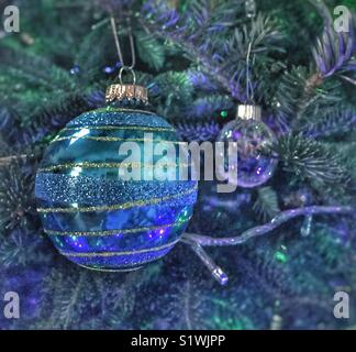 Fancy Christmas baubles hanging on the tree Stock Photo
