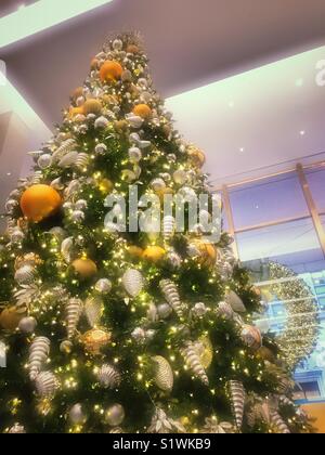 Huge brightly decorated Christmas tree in the lobby of MetLife building, New York City, USA Stock Photo