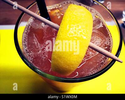 Iced tea with large lemon wedge close-up Stock Photo