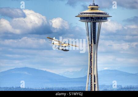 See playing from Kenmore air passing the space needle at a low altitude as it is landing at Lake Union in Seattle Washington Stock Photo