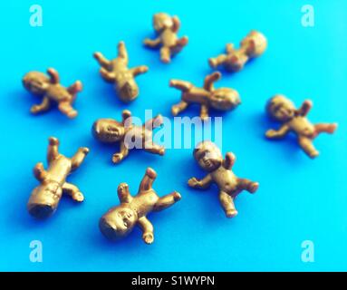 A bunch of mini gold baby figurines. Stock Photo