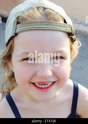 Smiling happy five-year-old girl with two missing front teeth. Stock Photo