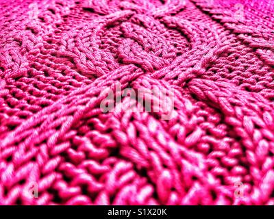 Hand knitted, bright pink, cotton sweater, low angle view Stock Photo