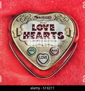 Limited edition Love Hearts tin on a red background Stock Photo