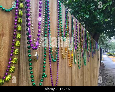 Mardi Gras beads on fence in New Orleans Stock Photo