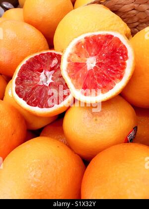Sliced and whole blood oranges close up. Stock Photo
