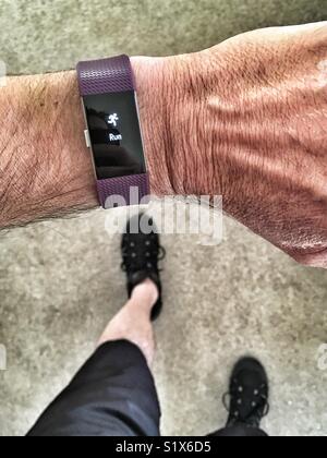 Man running with Fitbit Charge 2 set for a run Stock Photo