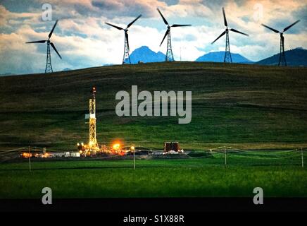 Wind farm in Alberta, Canada and gas well Stock Photo