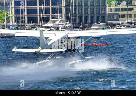 Kayaking in front of a float plane on Lake Union in Seattle Washington Stock Photo