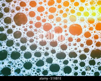 Closeup of bubble bath bubbles with rainbow light effect Stock Photo