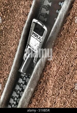 A zip on brown leather Stock Photo