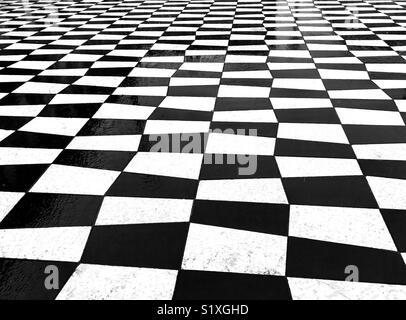 Pattern formed by black and white paving stones in a public square in Nice, France Stock Photo