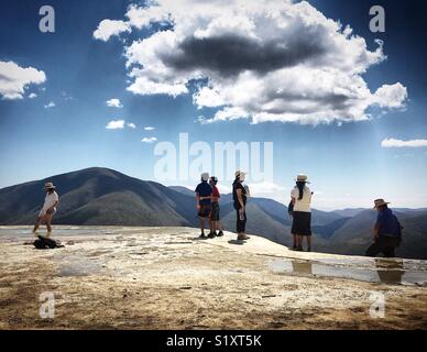 People walk in Hierve el Agua in Oaxaca, Mexico Stock Photo