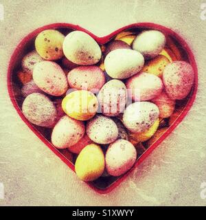 Chocolate Easter eggs in a red heart shaped box Stock Photo