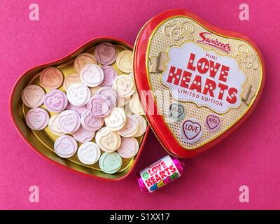 Love hearts in a tin, on pink Stock Photo