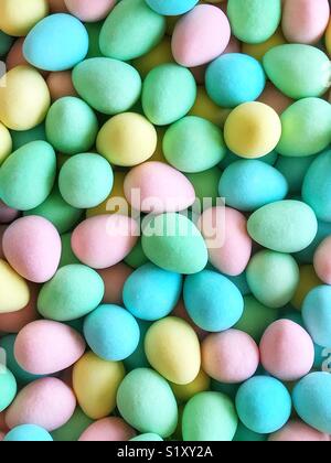 Pink, yellow, blue, and green sugar-coated chocolate mini eggs. Stock Photo