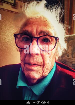 Elderly woman suffering from macular degeneration in her eyes. Stock Photo