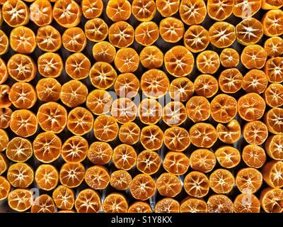 Limau kasturi, cut in a half and laid out on a baking tray. Citrus fruit, High angle view Stock Photo