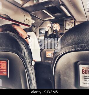 Stewardess giving a safety demonstration on board an EasyJet flight prior to take off Stock Photo