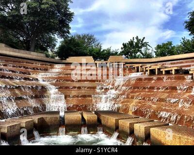 Water falls 38 feet over terraces into the eye of the active pool at the Fort Worth Water Gardens. The active pool has a path that allows visitors to experience the feel the heart of a cataract. Stock Photo