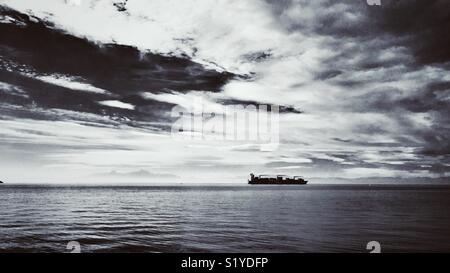 Black and white photo of container ship in Thessaloniki bay in Greece Stock Photo