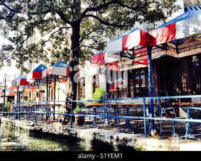Lone Star awnings line a restaurant along the river walk in San Antonio, Texas. Stock Photo