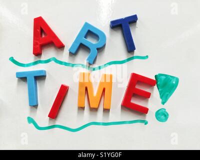 Magnetic alphabet letters forming words Art Time Stock Photo