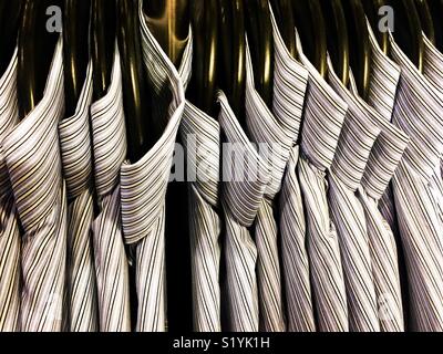 Rack of cotton shirts on hangers. Stock Photo