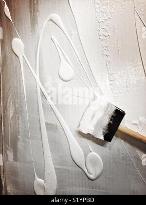 Painting white tempera paint on cardboard Stock Photo - Alamy