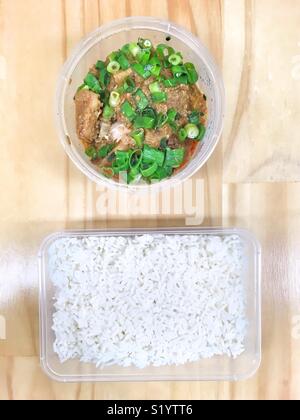 Pineapple and chicken curry with white rice, in takeaway containers. Stock Photo