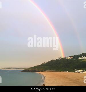 Double rainbow over Porthminster Beach, St Ives, Cornwall, looking east towards Carbis Bay Stock Photo