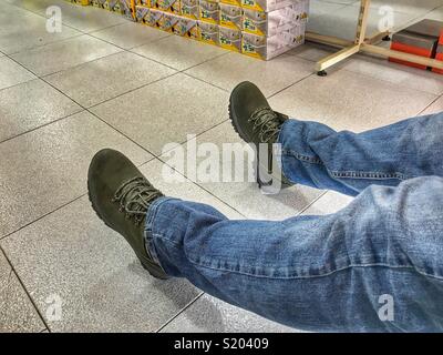 Trying on hiking boots in a Spanish shoe shop Stock Photo