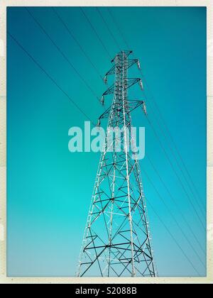 High voltage metallic electric tower isolated on a blue sky, France. Stock Photo