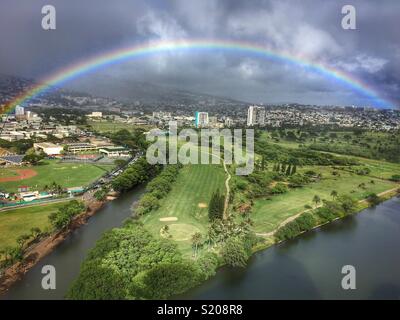 Rainbow over the Ala Wai Golf Course in Honolulu Hawaii Stock Photo