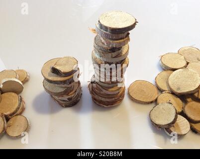 Stacks of wooden discs from the stem of a birch tree on white background Stock Photo