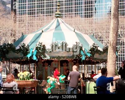 Festive children’s merry-go-round carousel, Bryant Park, New York City, USA Stock Photo