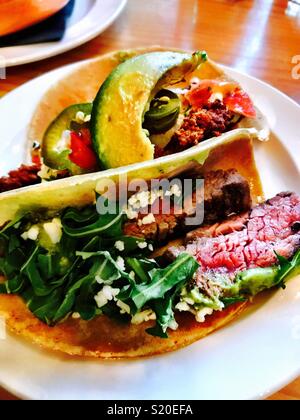A carne asada street taco sits cooling on a plate. Stock Photo