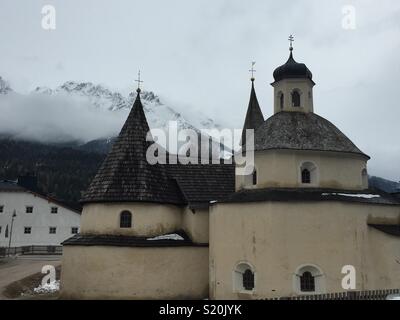 Convent church of San Candido on a cloudy day. Stock Photo