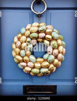 Easter wreath on blue front door of a house. UK Stock Photo