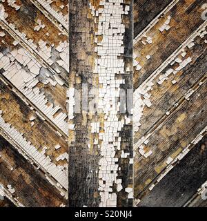 Peeling weathered white paint on a wooden wall Stock Photo