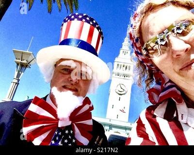 Patriotic protesters, man dressed as Uncle Sam, at the Embarcadero, San Francisco, California, USA.