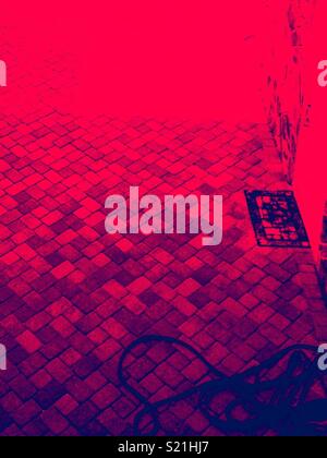 Red filtered photo of brick patio as seen from second floor Stock Photo
