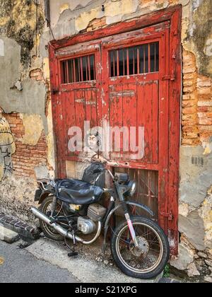 Art imitating life in Penang. Stock Photo